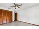Bedroom featuring spacious closet with bi-fold doors and neutral tile floors at 1382 Aladdin Rd, Spring Hill, FL 34609