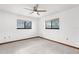 Bright bedroom with tile flooring, two windows and a ceiling fan at 1382 Aladdin Rd, Spring Hill, FL 34609