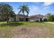 Charming single-story home featuring a well-kept lawn, mature tree, and tasteful landscaping at 1382 Aladdin Rd, Spring Hill, FL 34609