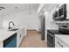 Updated kitchen featuring stainless steel appliances, sleek countertops and backsplash, with white cabinets and modern fixtures at 1382 Aladdin Rd, Spring Hill, FL 34609