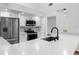 Bright kitchen featuring modern appliances, white cabinets, stainless steel fridge, and stylish countertops and backsplash at 1382 Aladdin Rd, Spring Hill, FL 34609