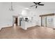 Spacious kitchen with stainless steel appliances, white cabinetry, breakfast bar, and adjacent dining area with backyard access at 1382 Aladdin Rd, Spring Hill, FL 34609