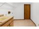 Functional laundry room with sink, storage shelves, and a door leading to other areas of the home at 1382 Aladdin Rd, Spring Hill, FL 34609