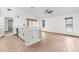 Open-concept living room with tile flooring, ceiling fan, and natural light at 1382 Aladdin Rd, Spring Hill, FL 34609