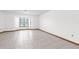 Bright living room with tile floors, neutral walls, bay windows, and wood trim at 1382 Aladdin Rd, Spring Hill, FL 34609