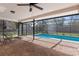 Inviting screened-in pool area with brick patio and adjacent hot tub, perfect for outdoor relaxation at 1382 Aladdin Rd, Spring Hill, FL 34609