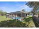 Inviting screened-in pool area with a well-maintained backyard and lovely landscaping at 1382 Aladdin Rd, Spring Hill, FL 34609