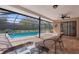 Relaxing screened-in pool area featuring a pool, hot tub, brick patio, and ceiling fan for comfort at 1382 Aladdin Rd, Spring Hill, FL 34609