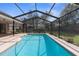 Inviting screened-in pool with deck area, surrounded by well-maintained landscaping and fencing at 1382 Aladdin Rd, Spring Hill, FL 34609
