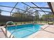 Inviting in-ground pool is screened-in and has brick surround and provides a perfect backyard entertaining oasis at 1382 Aladdin Rd, Spring Hill, FL 34609
