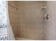 Tiled shower featuring a neutral color scheme, shower head, and soap dish at 1382 Aladdin Rd, Spring Hill, FL 34609