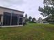 View of the backyard and screened in patio and community pool at 15772 Stable Run Dr, Spring Hill, FL 34610