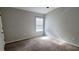 A spacious bedroom with natural light streaming through a window at 15772 Stable Run Dr, Spring Hill, FL 34610