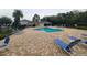 A community pool with lounge chairs and a covered pavilion at 15772 Stable Run Dr, Spring Hill, FL 34610