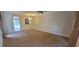 Open-concept living room featuring neutral walls, carpet and access to the kitchen at 15772 Stable Run Dr, Spring Hill, FL 34610