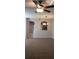 Living room view featuring a ceiling fan, carpet, arched entry and a passthrough to the kitchen at 15772 Stable Run Dr, Spring Hill, FL 34610