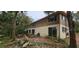 A two-story home with a backyard with trees and large sliding glass doors at 17932 Wendy Sue Ave, Hudson, FL 34667