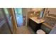 Neutral bathroom with a tiled shower, vanity, and updated fixtures; opens to another room at 17932 Wendy Sue Ave, Hudson, FL 34667