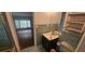 A vintage bathroom with green tile walls and a dark vanity at 17932 Wendy Sue Ave, Hudson, FL 34667