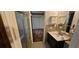 Bathroom featuring a shower and sink with mirror and overhead storage at 17932 Wendy Sue Ave, Hudson, FL 34667