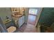 Vintage bathroom features green tile, a toilet, and vanity with cultured marble countertop at 17932 Wendy Sue Ave, Hudson, FL 34667