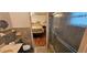 Bathroom featuring a shower and view into the bedroom with hardwood flooring and a bed at 17932 Wendy Sue Ave, Hudson, FL 34667