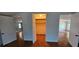 Bedroom showcasing closet with mirrored doors and access to two adjacent rooms at 17932 Wendy Sue Ave, Hudson, FL 34667