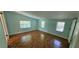 Light blue bedroom boasts parquet floors, multiple windows, and a side closet at 17932 Wendy Sue Ave, Hudson, FL 34667