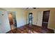 Bedroom with light yellow walls, wood-look floors, and doors to the bathroom and walk-in closet at 17932 Wendy Sue Ave, Hudson, FL 34667