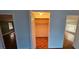 A bedroom closet with bifold doors and hardwood floors provides ample storage space at 17932 Wendy Sue Ave, Hudson, FL 34667