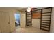 Bedroom with tile flooring, shelving, and an ensuite bathroom at 17932 Wendy Sue Ave, Hudson, FL 34667