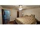 Spacious bedroom with hardwood floors, a bed, and light floral wallpaper at 17932 Wendy Sue Ave, Hudson, FL 34667