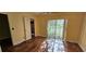 Bedroom with light yellow walls, wood-look flooring and sliding glass door to the outside at 17932 Wendy Sue Ave, Hudson, FL 34667