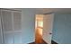 Bedroom with hardwood floors and a view into the next room at 17932 Wendy Sue Ave, Hudson, FL 34667