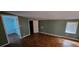 Spacious bedroom with parquet floors, olive green walls, and natural light from the window at 17932 Wendy Sue Ave, Hudson, FL 34667