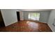 A bedroom with parquet floors, light blue walls, and windows with backyard views at 17932 Wendy Sue Ave, Hudson, FL 34667