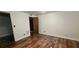 A bright bedroom with hard wood floors and view into a closet at 17932 Wendy Sue Ave, Hudson, FL 34667
