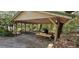 Covered carport with wooden beams, offering shelter for vehicles or outdoor activities at 17932 Wendy Sue Ave, Hudson, FL 34667