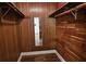 Walk-in closet with wood paneling and shelving at 17932 Wendy Sue Ave, Hudson, FL 34667