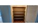 Interior shot of a narrow closet with shelves, accessed via a blue bedroom at 17932 Wendy Sue Ave, Hudson, FL 34667