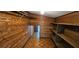 Cozy closet with wood paneled walls, wood flooring and custom built in shelving at 17932 Wendy Sue Ave, Hudson, FL 34667
