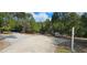 A long paved driveway leads through lush trees, offering privacy and tranquility at 17932 Wendy Sue Ave, Hudson, FL 34667