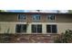 The back of the house features three sliding glass doors on the first floor and windows on the second, bringing in lots of light at 17932 Wendy Sue Ave, Hudson, FL 34667