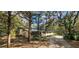 Two-story home showcasing lush landscaping and a metal roof, blending nature with residential charm at 17932 Wendy Sue Ave, Hudson, FL 34667