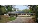 A single-story home with mature trees and a long driveway at 17932 Wendy Sue Ave, Hudson, FL 34667