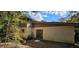 The back of this two-story home features a patio, mature landscaping, and a combination of siding and stucco at 17932 Wendy Sue Ave, Hudson, FL 34667
