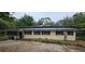 A single-story home with mature trees and a dark-colored roof at 17932 Wendy Sue Ave, Hudson, FL 34667