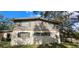 Two-story home with neutral siding, window shutters, and mature trees at 17932 Wendy Sue Ave, Hudson, FL 34667