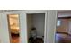 Hallway with hard wood floors with doors to bedroom and utility room at 17932 Wendy Sue Ave, Hudson, FL 34667