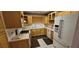 Kitchen with tile floors, wooden cabinets, and white appliances at 17932 Wendy Sue Ave, Hudson, FL 34667
